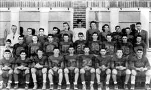 The 1942-1943 Downs Dragons Football team. Herman "Joe" Hale, one of the captains of the team, is third from left in the front row.  The team went 9-0, scoring 188 points to their opponents' zero points.
